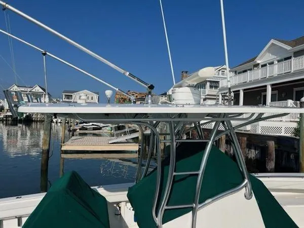 Slide: The Image of Spectre 34 boat docked near waterfront homes, clear sky, 2008 model. - 12
