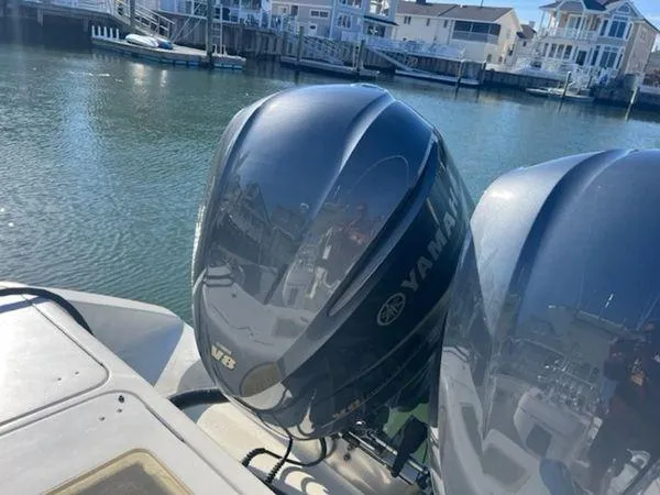 Slide: The Image of Twin Yamaha outboard motors on a 2008 Spectre 34 boat, docked in a marina. - 15