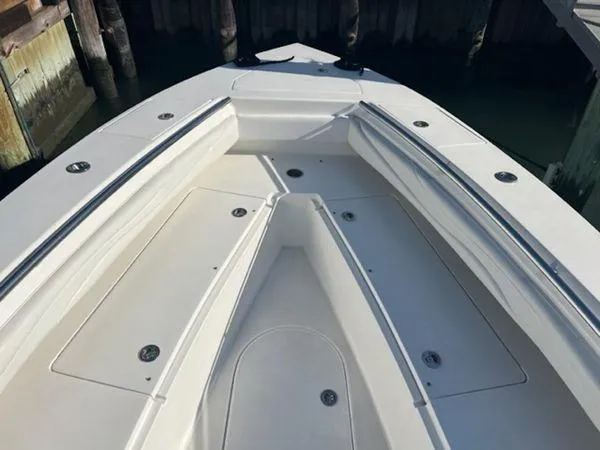 Slide: The Image of Bow of a 2008 Spectre 34 boat with sleek seating and storage compartments. - 27
