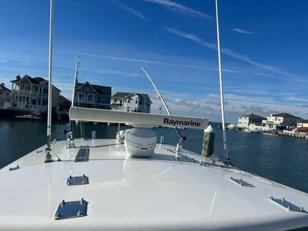 Slide: The Image of Bow view of 2008 Spectre 34 boat with Raymarine equipment, docked near waterfront homes. - 28