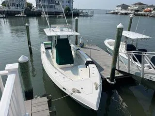 Slide: The Image of Spectre 34 boat docked at marina, 2008 model, calm waters, residential backdrop. - 3