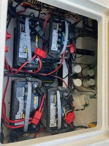 Slide: The Image of Battery compartment of a 2008 Spectre 34 boat with multiple batteries and wiring. - 47