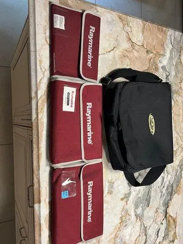 Slide: The Image of Raymarine equipment bags and Spectre 34 carrying case on marble surface, 2008 model. - 49