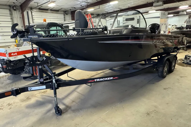 The Image of 2024 Tracker Targa V-18 Combo boat on trailer in indoor storage facility. - 1