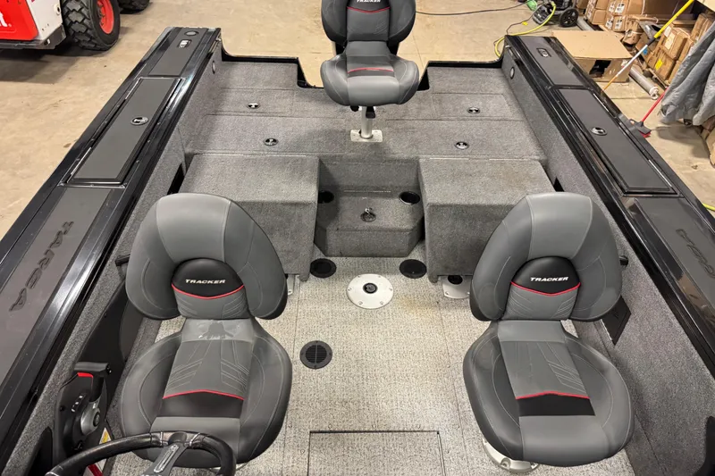 Slide: The Image of 2024 Tracker Targa V-18 Combo boat interior with gray seating and storage compartments. - 15