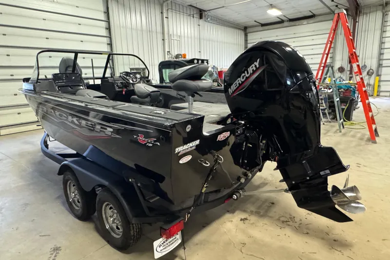 Slide: The Image of 2024 Tracker Targa V-18 Combo boat with Mercury engine in a garage setting. - 5