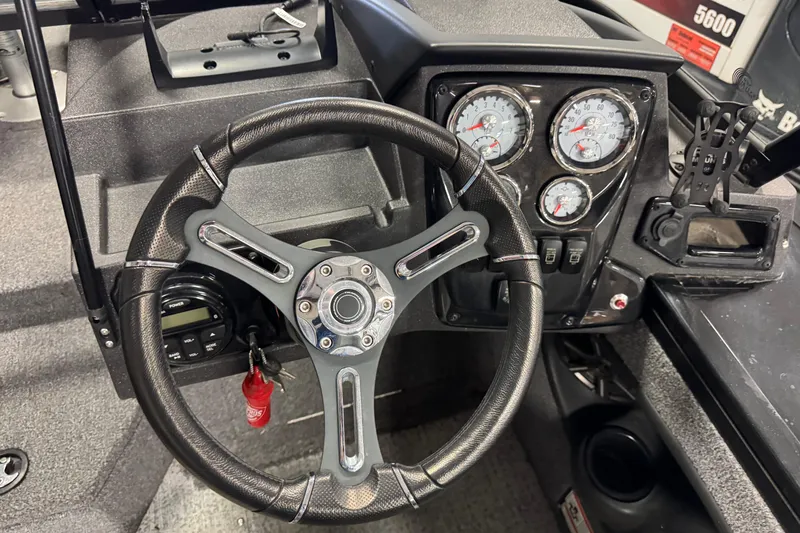 Slide: The Image of 2024 Tracker Targa V-18 Combo dashboard with steering wheel and gauges. - 6