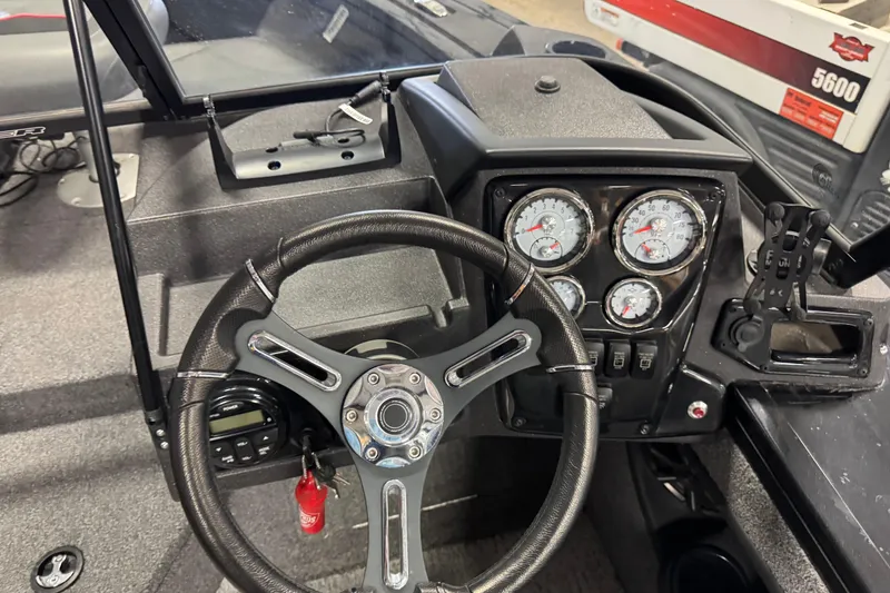 Slide: The Image of Steering console of 2024 Tracker Targa V-18 Combo boat with gauges and controls. - 7