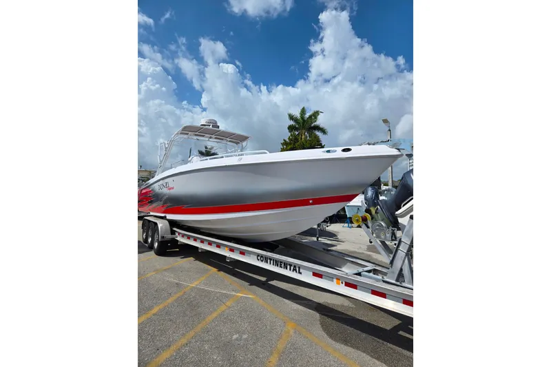 Slide: The Image of 2007 Donzi 35 ZF Daytona boat on trailer under blue sky. - 1
