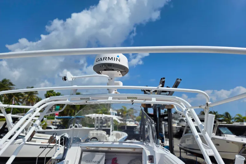 Slide: The Image of 2007 Donzi 35 ZF Daytona boat with Garmin radar, docked under a clear blue sky. - 12