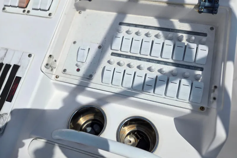 Slide: The Image of Control panel of a 2007 Donzi 35 ZF Daytona boat with switches and cup holders. - 14