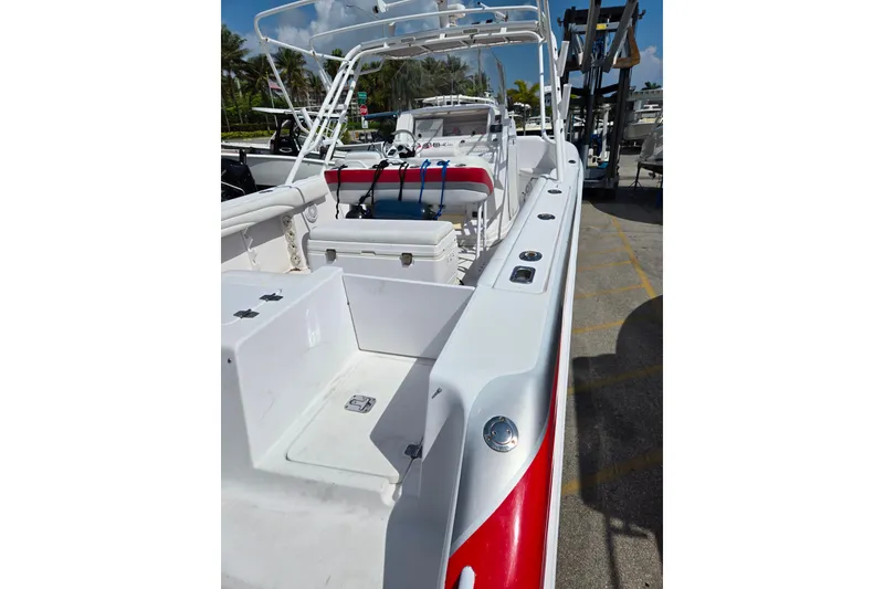 Slide: The Image of 2007 Donzi 35 ZF Daytona boat with red and white detailing, docked outdoors. - 23
