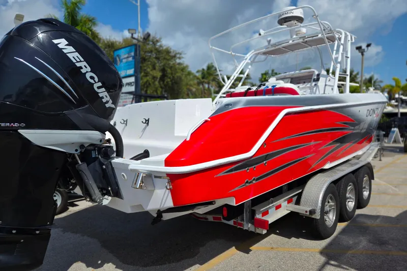 Slide: The Image of 2007 Donzi 35 ZF Daytona boat with vibrant red design and Mercury engine. - 3