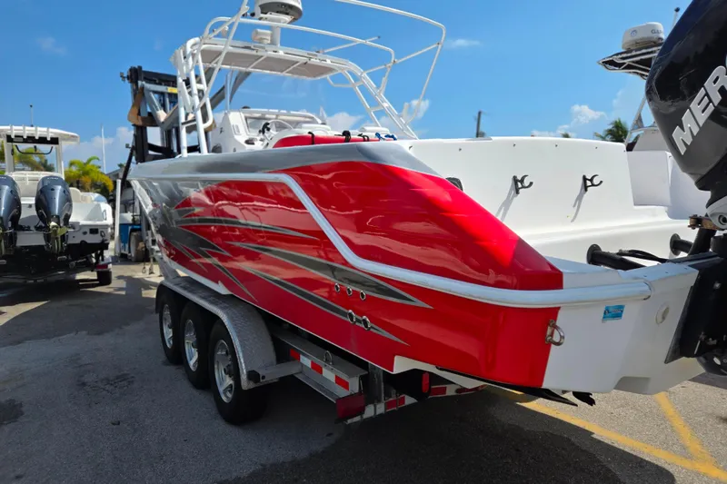 Slide: The Image of 2007 Donzi 35 ZF Daytona boat with vibrant red and silver detailing on a trailer. - 4