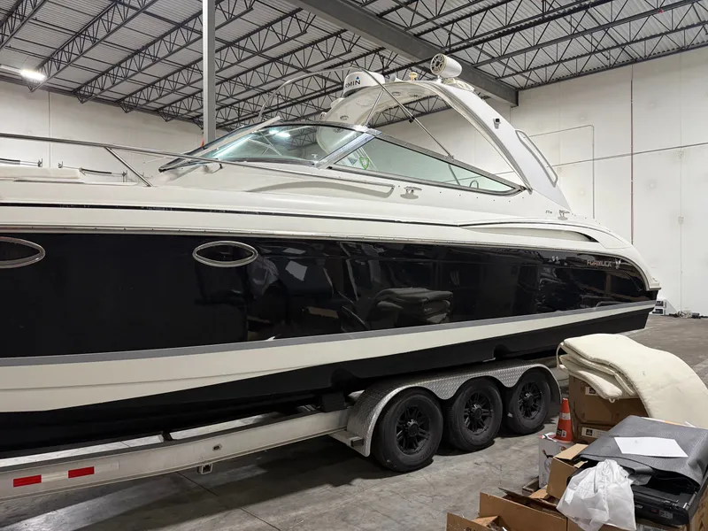 Slide: The Image of 2005 Formula 370 Super Sport boat in warehouse on trailer. - 12