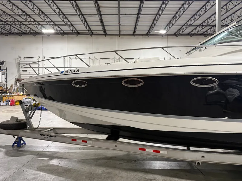 Slide: The Image of 2005 Formula 370 Super Sport boat in warehouse on trailer. - 13