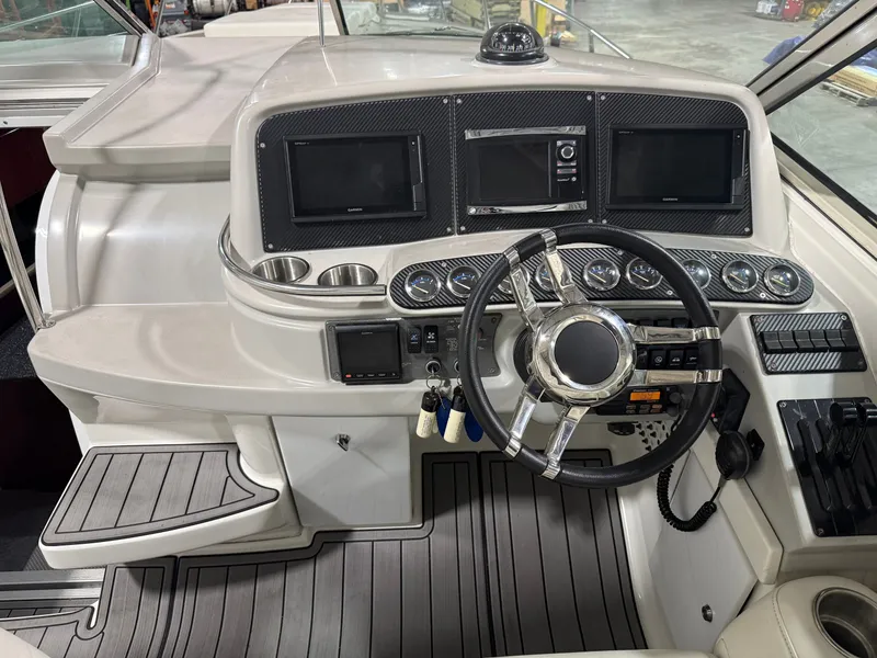 Slide: The Image of Cockpit of a 2005 Formula 370 Super Sport boat with steering wheel and instruments. - 2