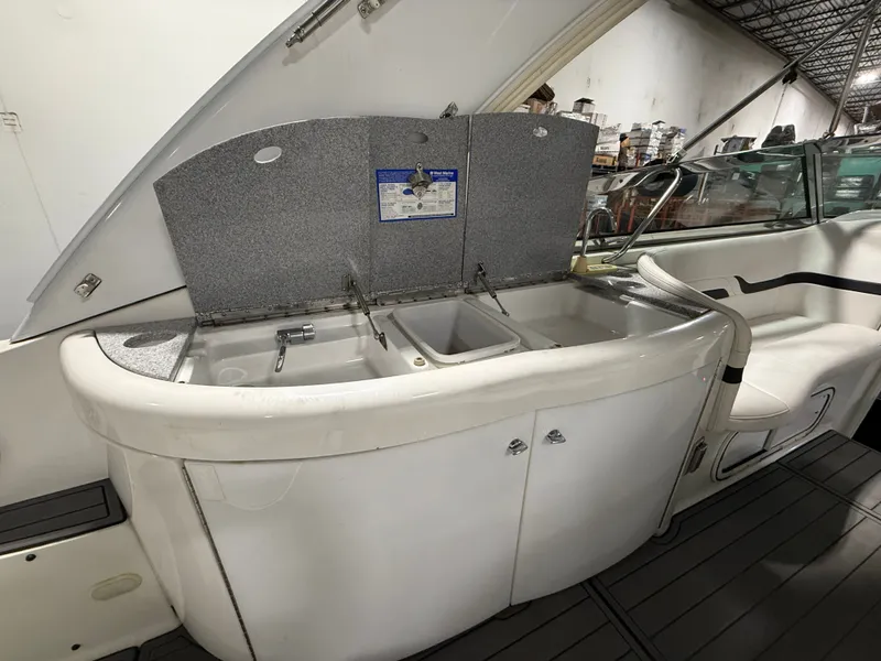Slide: The Image of 2005 Formula 370 Super Sport boat kitchen with sink and storage. - 24