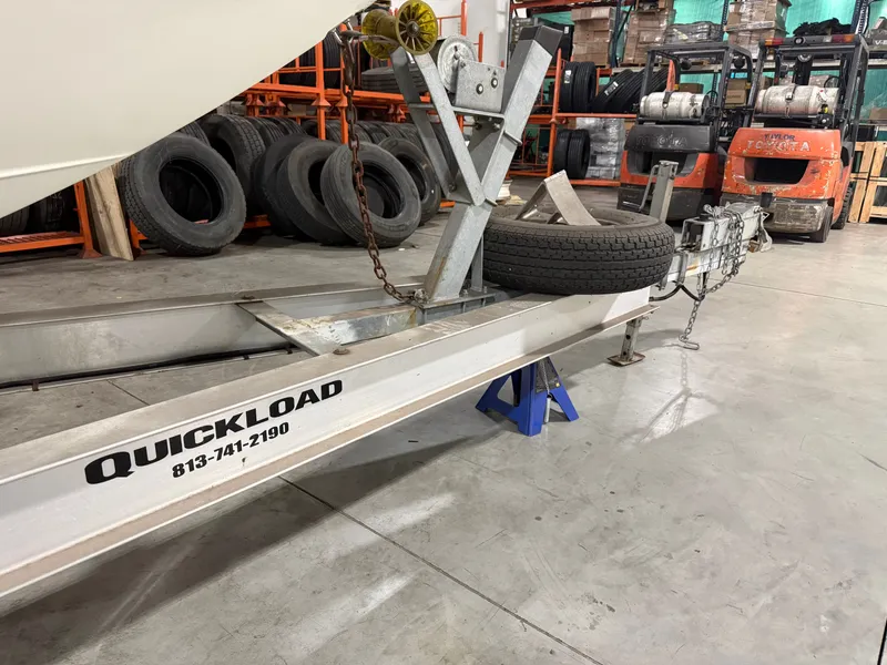 Slide: The Image of Boat trailer in warehouse with spare tire and forklifts. - 40