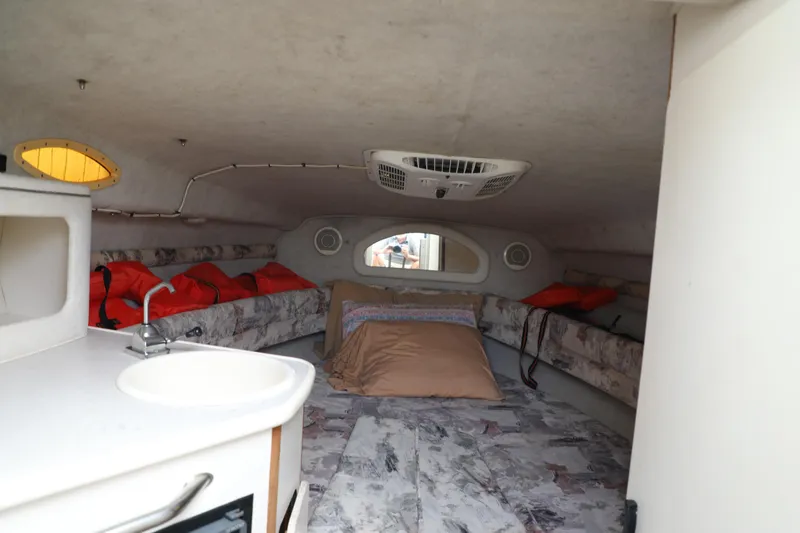 Slide: The Image of Interior cabin of 1998 Searay Sundancer boat with seating, sink, and life jackets. - 11