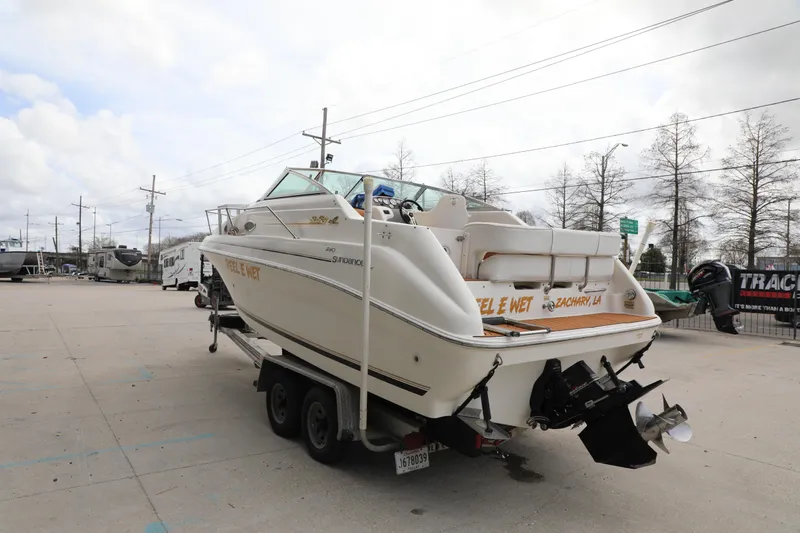 Slide: The Image of 1998 Searay Sundancer boat on trailer in parking lot, overcast sky. - 5