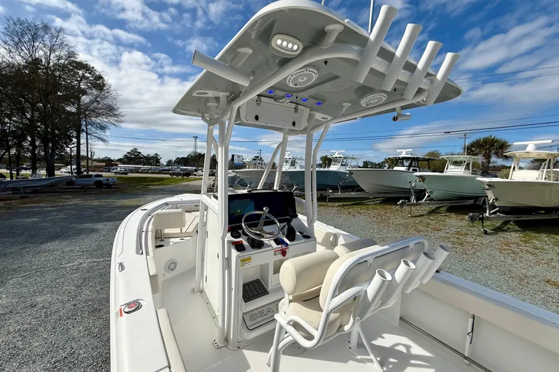 Slide: The Image of 2022 Sea Hunt Ultra 229 boat interior with seating and steering wheel. - 19