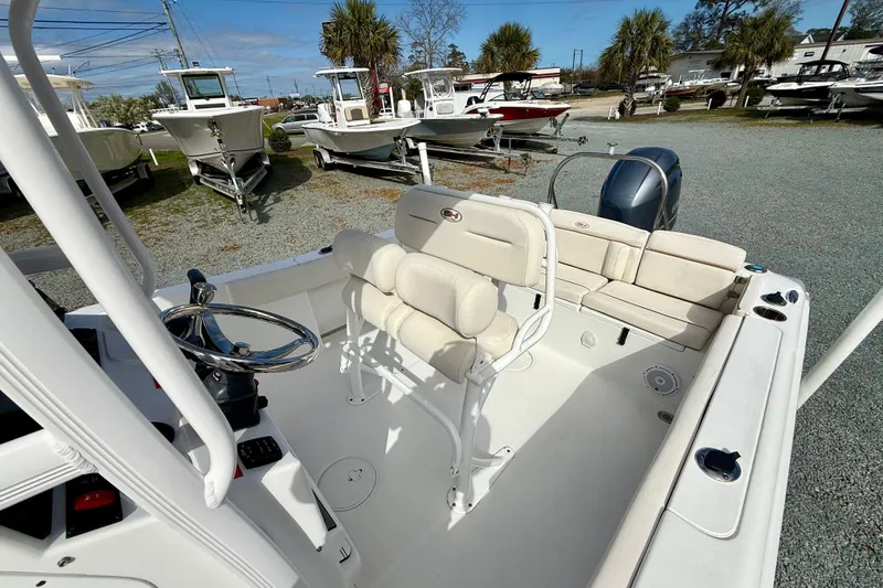 Slide: The Image of 2022 Sea Hunt Ultra 229 boat interior with seating and steering console. - 20