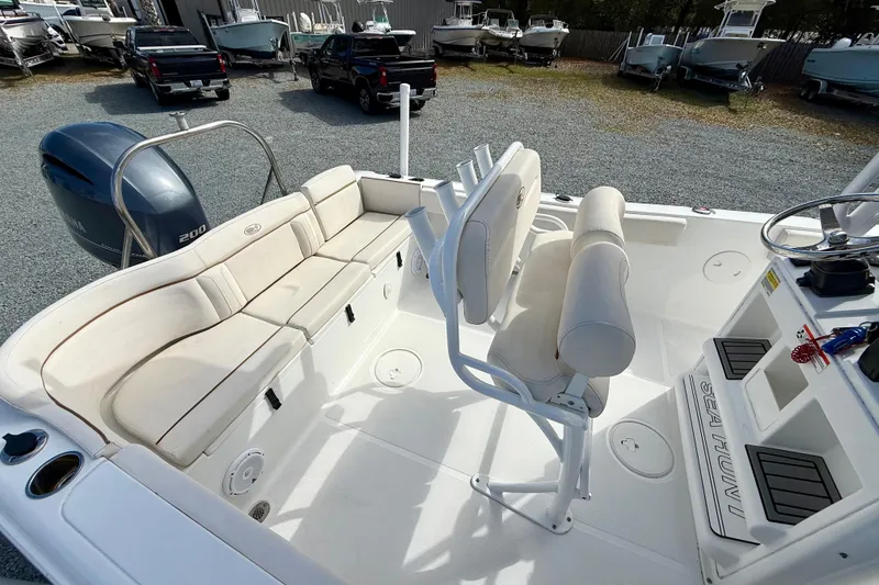 Slide: The Image of 2022 Sea Hunt Ultra 229 boat interior with seating and steering wheel. - 21