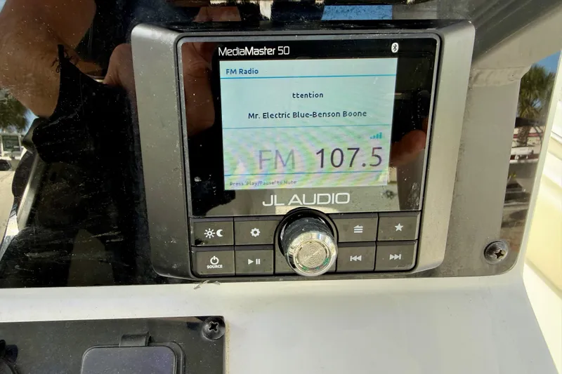 Slide: The Image of 2022 Sea Hunt Ultra 229 boat console with Garmin marine radio installed. - 29