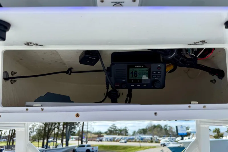 Slide: The Image of 2022 Sea Hunt Ultra 229 boat interior storage compartment with open door. - 30