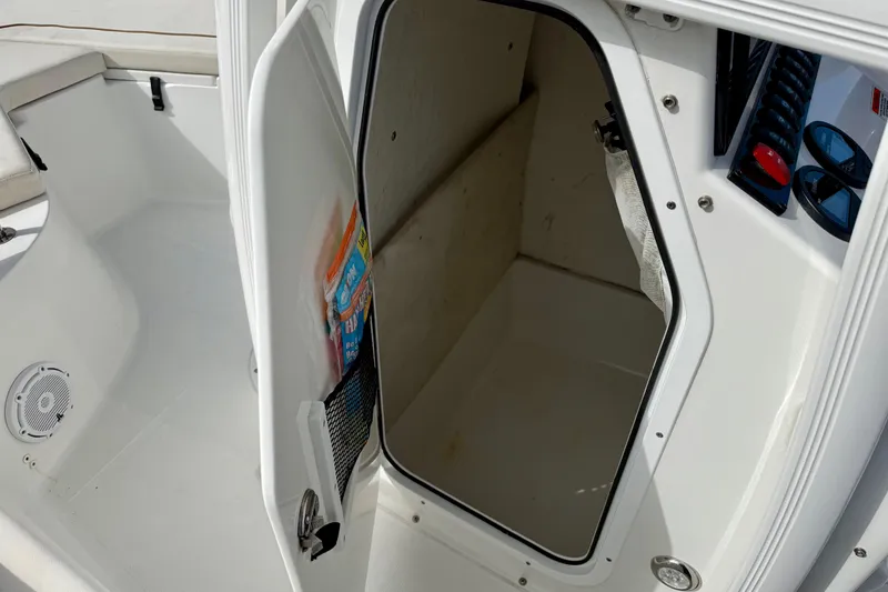 Slide: The Image of Storage compartment of 2022 Sea Hunt Ultra 229 with life jackets and ropes. - 31