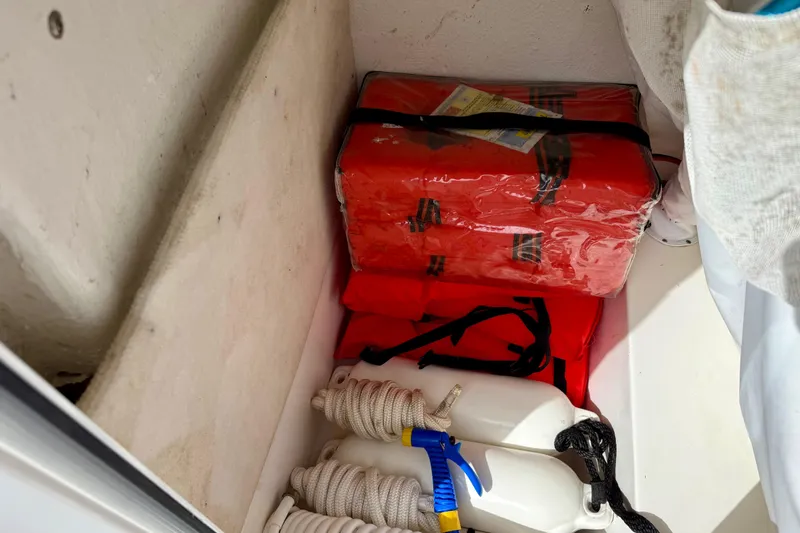 Slide: The Image of 2022 Sea Hunt Ultra 229 boat interior with white seating and spacious layout. - 32