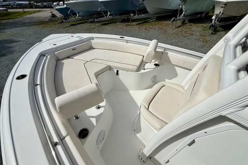 Slide: The Image of 2022 Sea Hunt Ultra 229 boat interior with cushioned seating and storage compartments. - 33