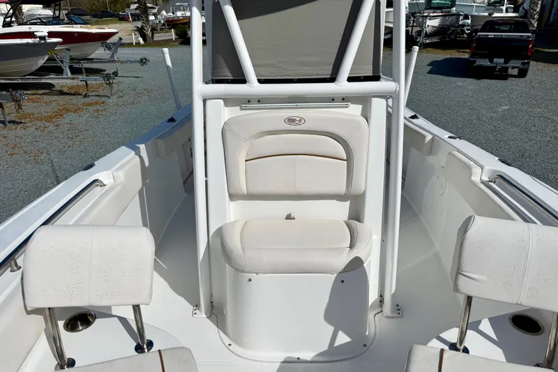 Slide: The Image of 2022 Sea Hunt Ultra 229 boat interior with seating and storage cover. - 36
