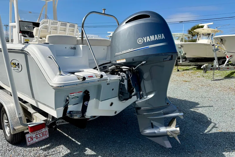 Slide: The Image of 2022 Sea Hunt Ultra 229 boat with Yamaha 200 engine, parked outdoors. - 4