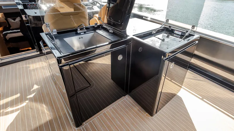 Slide: The Image of Luxury kitchen area on 2022 Pardo Yachts 50, featuring sleek black cabinetry and modern design. - 18