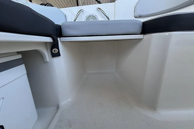 Slide: The Image of 2024 Bayliner Element M17 interior seating area with cushioned seats and storage. - 12
