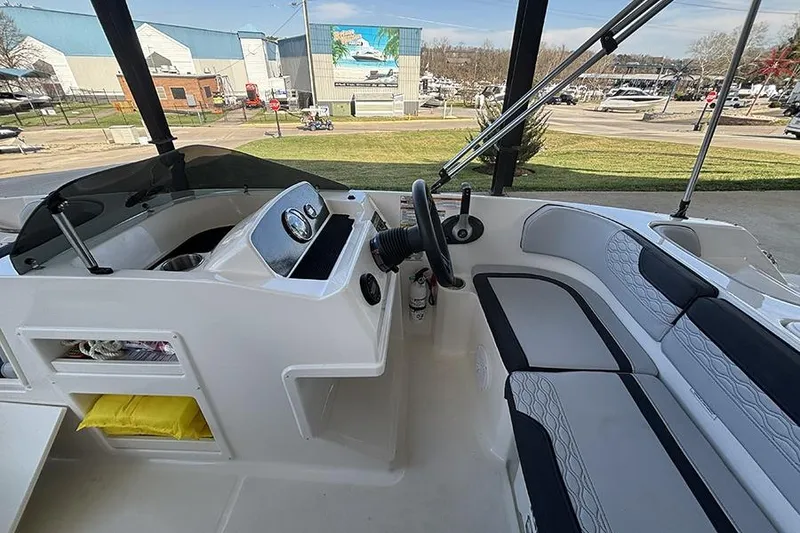 Slide: The Image of 2024 Bayliner Element M17 boat interior with steering wheel and seating area. - 15