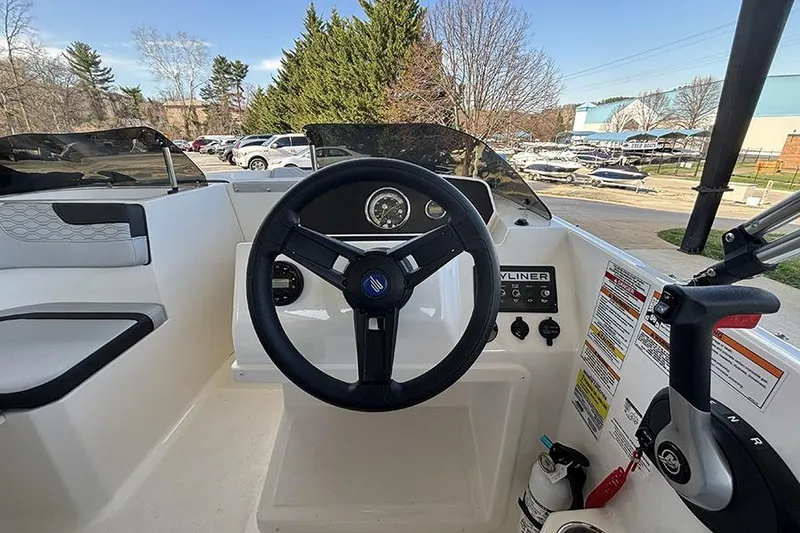 Slide: The Image of 2024 Bayliner Element M17 boat cockpit with steering wheel and control panel. - 16
