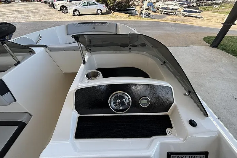 Slide: The Image of 2024 Bayliner Element M17 boat dashboard with gauges and windshield. - 17