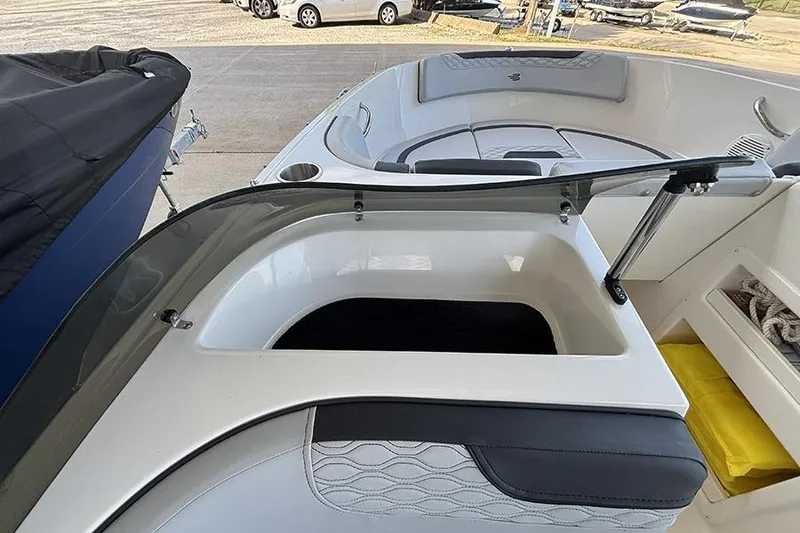 Slide: The Image of 2024 Bayliner Element M17 boat interior with seating and storage compartments. - 18