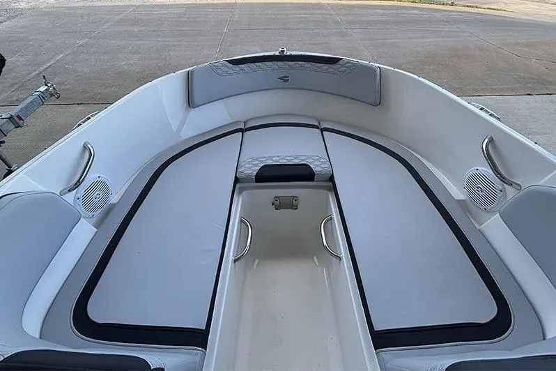 Slide: The Image of 2024 Bayliner Element M17 boat interior with cushioned seating and storage compartments. - 21