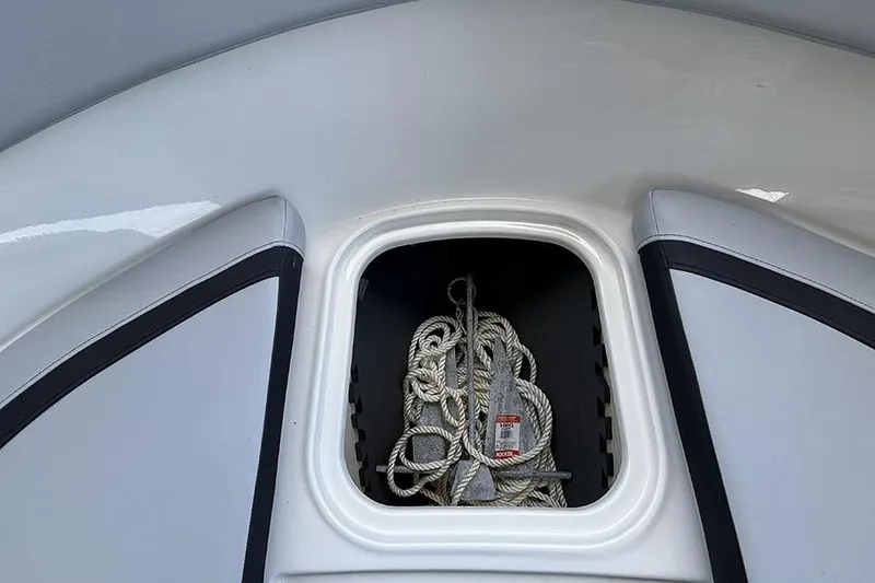 Slide: The Image of 2024 Bayliner Element M17 boat storage compartment with rope inside. - 26