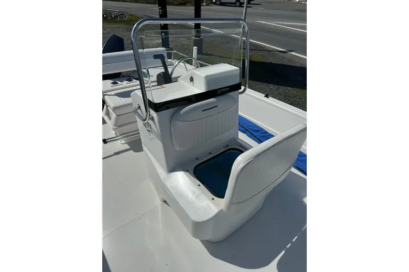 Slide: The Image of 2009 Triumph 1700 Skiff boat interior with steering console and seating. - 2
