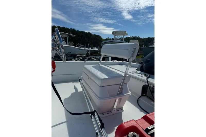 Slide: The Image of 2009 Triumph 1700 Skiff boat interior with white seating and steering wheel. - 3