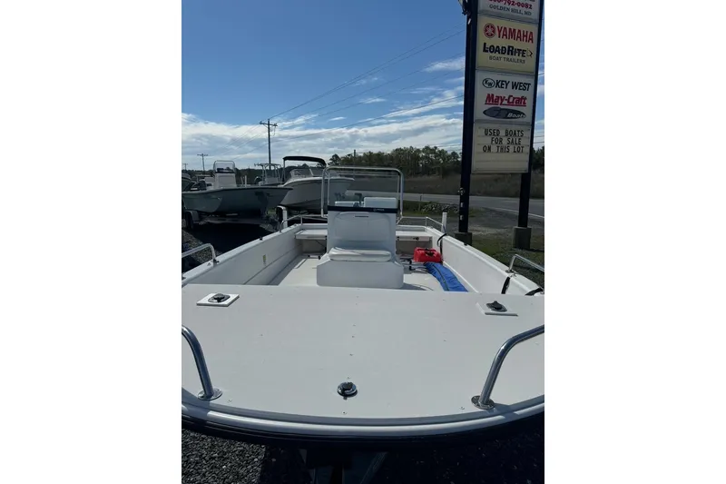 Slide: The Image of 2009 Triumph 1700 Skiff boat on display at a dealership lot. - 4