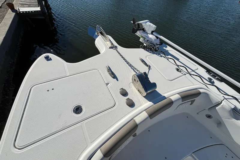 Slide: The Image of 2023 World Cat 295 CC boat deck with anchor and fishing equipment. - 16