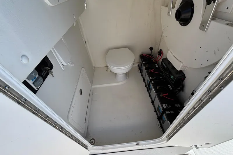 Slide: The Image of 2023 World Cat 295 CC interior with marine toilet and battery setup. - 20