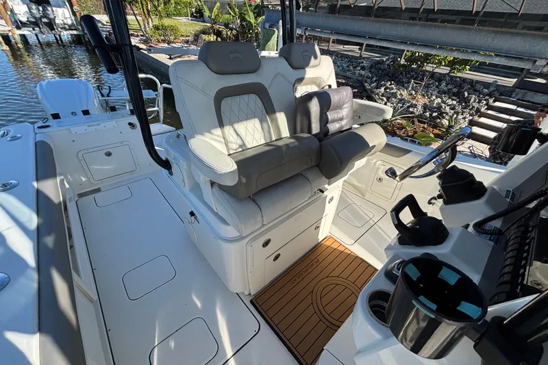 Slide: The Image of 2023 World Cat 295 CC boat interior with luxurious seating and modern helm controls. - 23