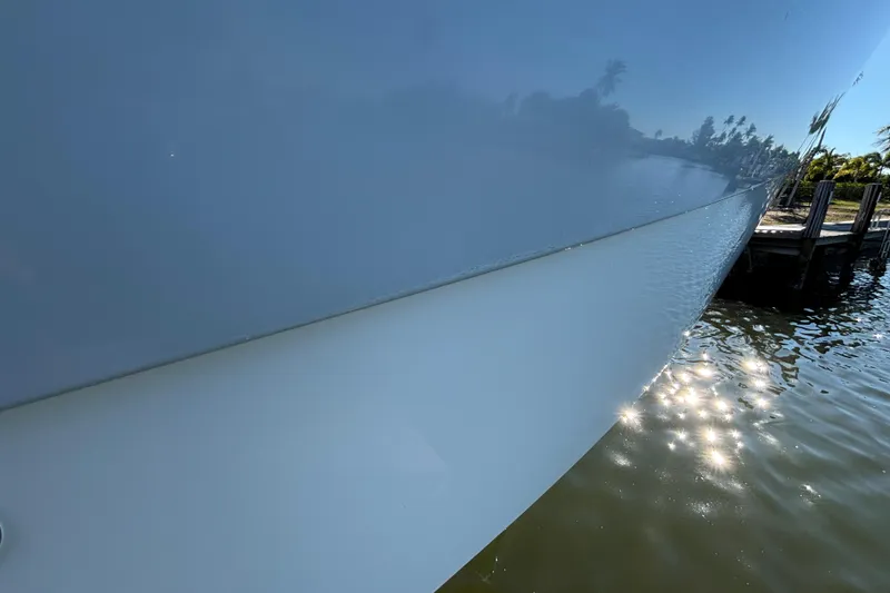 Slide: The Image of Close-up of 2023 World Cat 295 CC boat hull reflecting sunlight on water. - 24